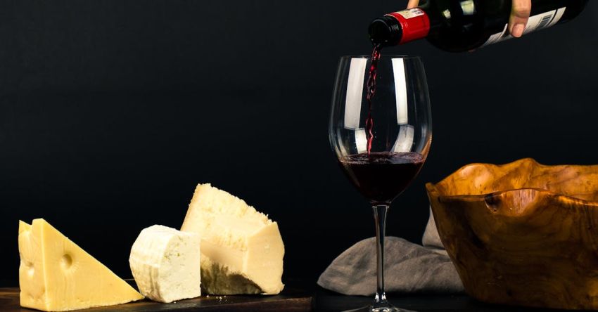 Pairing Fonts - Photo of Person Pouring Wine into Glass besides Some Cheese Pairings