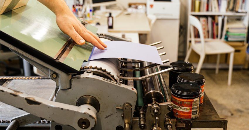 Variable Fonts - Hand of Man Working with Printing Tools using Machinery